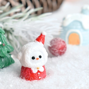 Miniature resin Christmas snowman figurine wearing a red hat in a festive winter scene