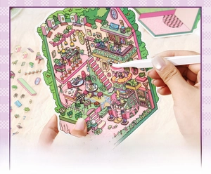 Close-up of hand applying cartoon house stickers with tweezers for DIY scrapbooking