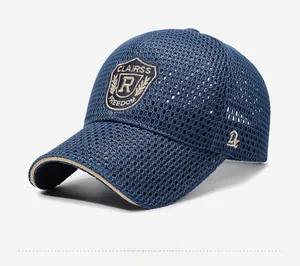 Detail view of navy mesh baseball cap with embroidered shield badge and beige brim trim