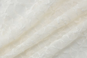 Détail macro du tissu en dentelle blanche de haute qualité avec texture en maille fine