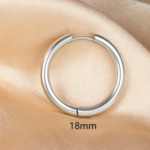 Detailed 18mm polished stainless steel hoop earring shown on champagne satin fabric
