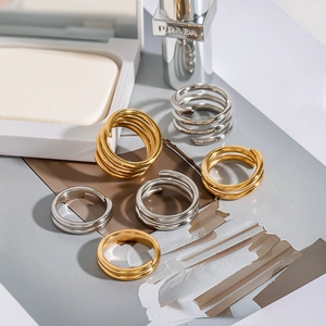 Minimalist spiral layered stainless steel ring set in polished gold and silver finishes