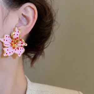 Elegant floral petal stud earrings in pink enamel finish with golden metallic trim