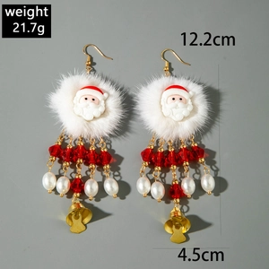 Detailed view of beaded Santa Claus earrings with red tassels and golden bells on grey