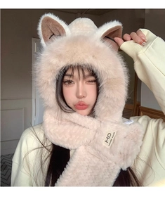 Detailed texture of beige faux fur on a fox-eared hat and scarf combo with brand label