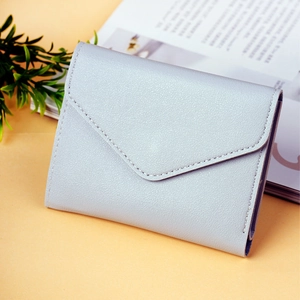 Detail of light grey lychee pattern leather wallet with envelope flap and tiered design