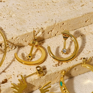 Chic 18K gold plated crescent moon earrings with crystals on beige travertine stone