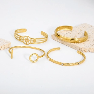 Four gold stainless steel bracelets with hollow sunflower and celestial engraved designs