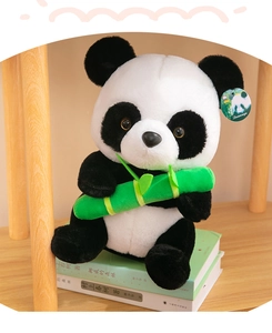 Detailed view of a cute panda plush toy holding green bamboo sitting on stacked books