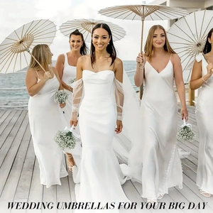 Elegant white wedding umbrellas for outdoor lawn parties and beach photography