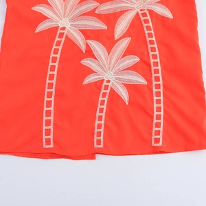 Orange sweet vacation dress featuring palm tree embroidery on a lightweight fabric hem