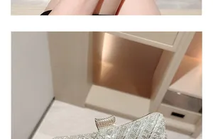 Detail of silver evening clutch with sparkling rhinestones and secure top lock closure