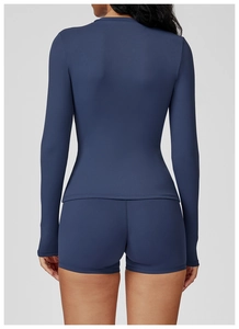 Rear view of dark blue long sleeve yoga top and tight shorts showing slim fit tailoring