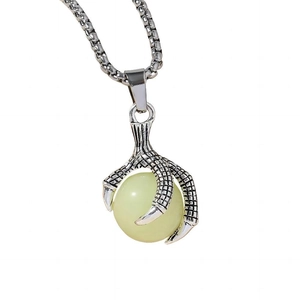 Vintage luminous dragon claw necklace with a glowing green eye orb on white background