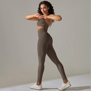 Detail view of seamless ribbed sports bra and high-waisted yoga leggings in dark taupe