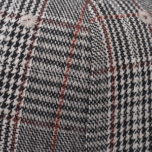 Close-up of classic houndstooth pattern fabric on a baseball cap with embroidered eyelet