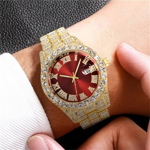 Close-up of gold iced-out men's watch with red dial and full diamond-set bracelet