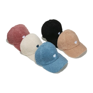 Detailed view of fleece baseball caps with heart embroidery in multiple pastel colors