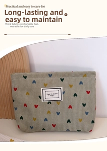 Detail of green corduroy makeup bag with colorful hearts and premium texture