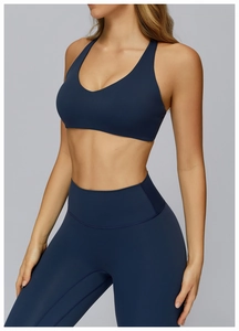 Close-up of navy blue brushed sports bra and high-waist leggings on a fitness model