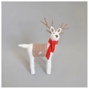 Macro shot of handmade wool felt reindeer decoration with brown antlers and red scarf