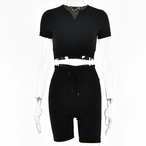 Detail of high waist drawstring shorts and half-zip black elastic athletic set