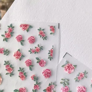 3D embossed floral nail art stickers featuring red and pink roses with green leaves