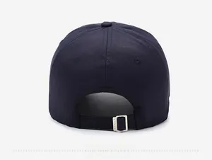 Detail view of the navy blue cotton baseball cap back with adjustable metal buckle strap