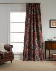 Bohemian curtain detail featuring geometric patterns and beige fringe tassels