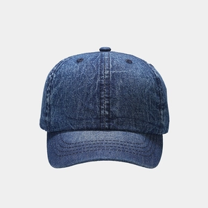 Front view of a vintage washed blue denim baseball cap with six-panel construction