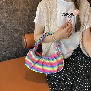 Detail shot of a pleated rainbow shoulder bag with gradient satin finish and cloud handle