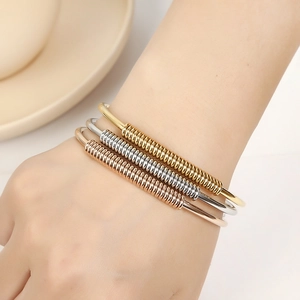 Three-piece stainless steel open bangle set in gold, silver, and rose gold finishes