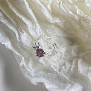 Macro detail of S925 silver irregular lava texture ring with pink zircon gemstone