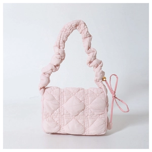 Pink quilted nylon shoulder bag with ruffled strap and satin bow decoration