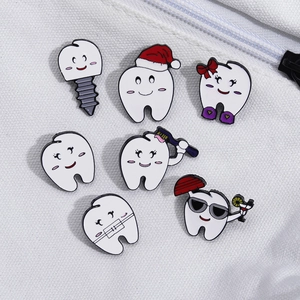 Set of funny tooth enamel pins with Christmas hats and dental themes on white canvas