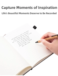 Close-up of hand writing with natural cork texture pen on a lined A5 eco-notebook