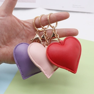 Three-piece heart-shaped PU leather keychains in purple, pink and red with gold rings