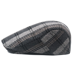 Detail shot of vintage grey plaid newsboy cap showing textured wool fabric and stitching
