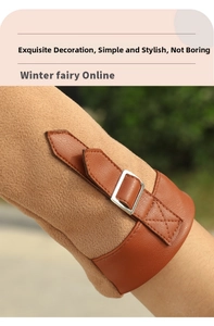 Detail view of winter suede glove cuff with leather strap and silver metal buckle