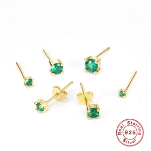 Detailed macro view of S925 sterling silver stud earrings with green round cut stones