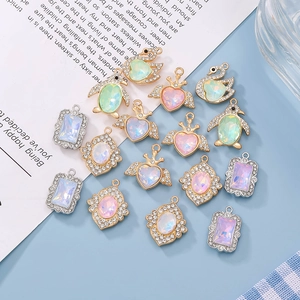 Mix of 10 multi-color mocha crystal alloy charms for DIY jewelry making on a blue background