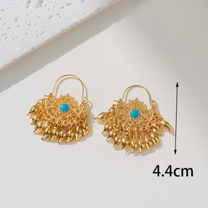 Detail view of 18K gold bohemian fan earrings with turquoise inlay and 4.4cm size mark