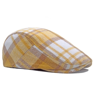 Detail of yellow plaid newsboy cap showing wool blend texture and classic british pattern