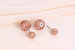 Macro detail of champagne crystal ball stud earrings with S925 silver hallmark engraving