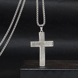 Detailed view of silver cross necklace pendant set with sparkling zircon stones