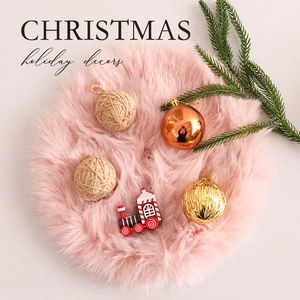 Pink plush Christmas tree skirt set with colorful ornaments and a small toy train