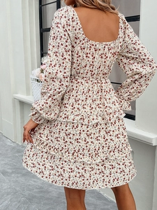 Detail of red floral dress featuring a square neck open back and ruffled mini skirt hemline