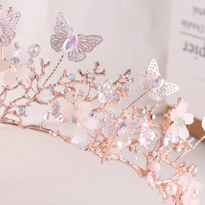 Detailed macro view of rose gold butterfly and flower bridal crown with shimmering crystals