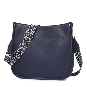 Navy blue lychee leather crossbody bag with a stylish leopard print wide strap