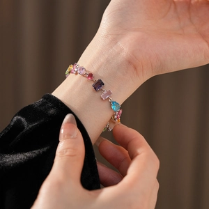 Close-up of multicolor oval zircon flower bracelet on wrist with pear and square cuts
